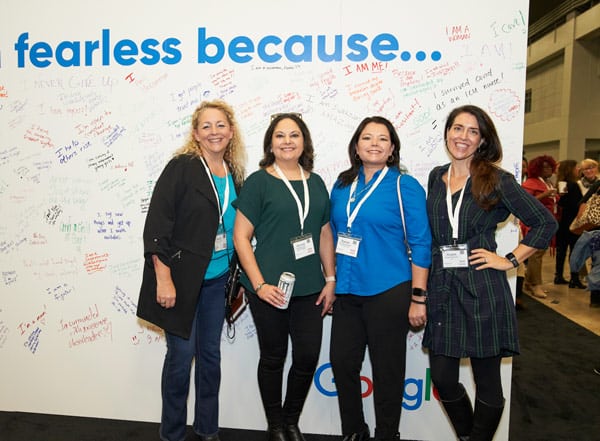 attendees posing in front of fearless backdrop at the TX Conference for Women